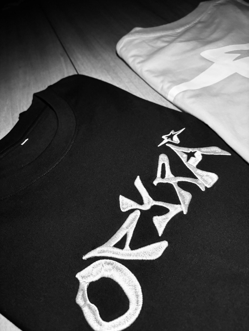 Black OPYRA tee with the logo embroidered in white